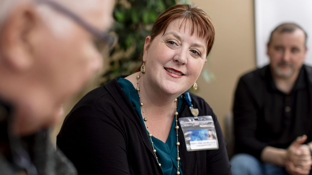 A tobacco cessation specialist talks with a participant in the residential program.
